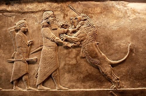 Stone carving of Assyrian King Ashurbanipal hunting lions, 6th century B.C.