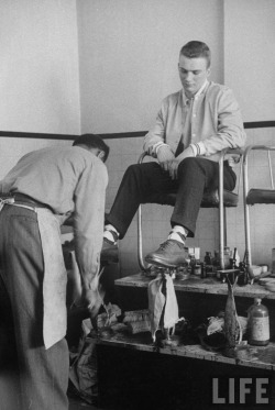 Teenager getting his shoes shined. St Louis, Missouri, April 1957 Photo by Nina Leen 