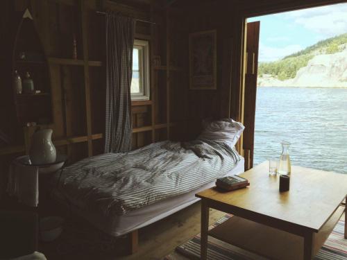 interior-design-home:Sometimes the simplest rooms are the best. Small cabin bedroom looks out onto t