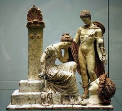 mini-girlz:Figurine with Hermes and female figure sitting on Tomb - at the Archaeological Museum of Catalonia, Barcelona