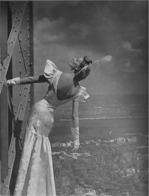 August, 1939: A Mainbocher model on the Eiffel Tower, photographed for Harper’s Bazaar by Geor