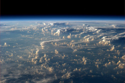 sixpenceee:  Clouds cast thousand-mile shadows into space when viewed aboard the International Space Station