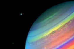 The planet Saturn, August 11, 1981, imaged by Voyager 2 from a range of 14.7 million kilometers (9.1 million miles). You can also see the moons Dione (right) and Enceladus. (NASA)