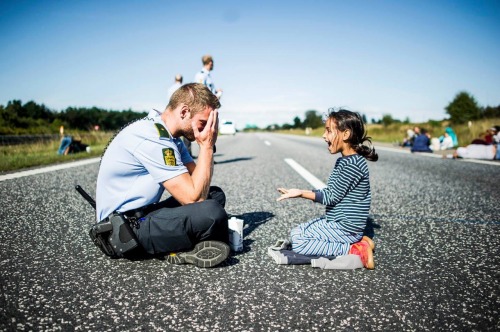 emt-monster:  Police officers play with Syrian children at the Danish border  This made my night