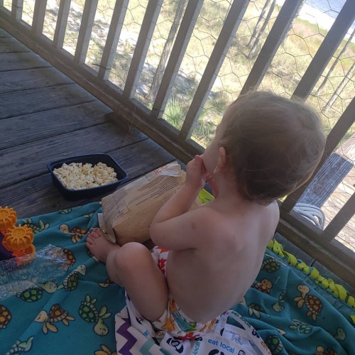 When mom gives you your own popcorn but you steal hers and hoard yours as well (at Carrabelle, Flori