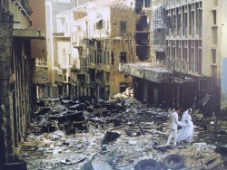 Just married a 23 year old Abed (Muslim groom) and 19 year old Arige (Christian bride) walk through the bombed ruins of Beirut, Lebanon, 1983.
