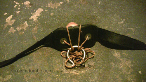 zerotsm:  Just another hogtie with a buttplug roped in, yes?  Well no.  The gag is tied to a ring in the floor, Then we put heavy clamps on Zerotsm’s pecs so his nipples stick out, then he’s hogtied on the floor with his head held to the floor by
