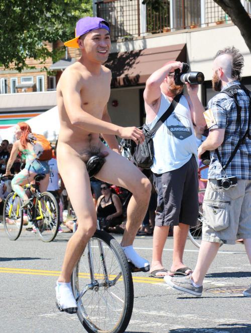 Unicyclist with purple and orange cap at Fremont Solstice.