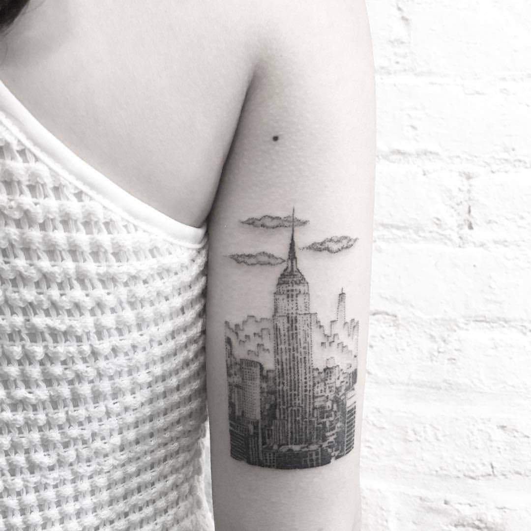 Empire State Building tattoo on the left side ribcage