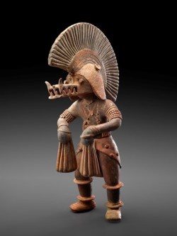 theancientwayoflife:  ~ Dancer with Crocodile Helmet. Datec 300 B.C.–A.D. 300  Place of origin/Culture: Colima Medium: Earthenware with traces of polychrome pigment.