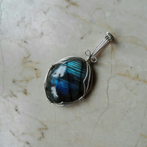 This is the same labradorite pendant just with different angles of light. Labradorite is truly amazi