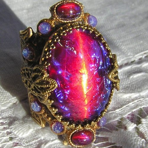 lady-sith:  highfunctioningdarklordofall:  farwin:  hoplophilia:  Dragon’s Breath is a very gorgeous type of opal made into many types of jewelry.  They look like gateways to other dimensions… :O  That top left one looks like it’s plotting to take