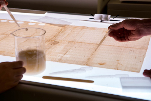 Treaty of Fort Pitt- realigning the record on a light table and lining the document with Japanese pa