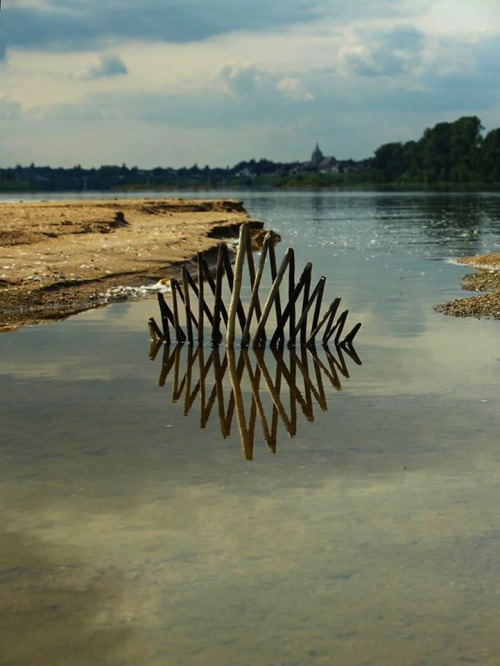 mymodernmet:  Back to Nature by Fesson Ludovic A series of sculptures made with natural materials like grass and wood featuring basic lines, arcs, and geometric forms that are buried directly on land or placed in water. 