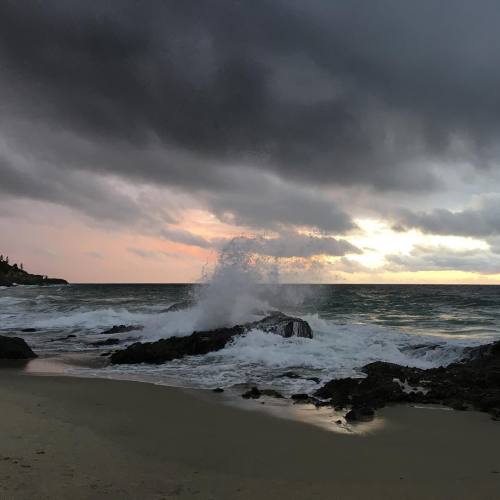 oddsight: [ID: A picture of the ocean shore just before sunset. There are large rocks lining the sho