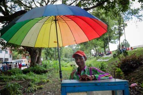 In Boudhanath, near Kathmandu, colourful umbrellas protect...