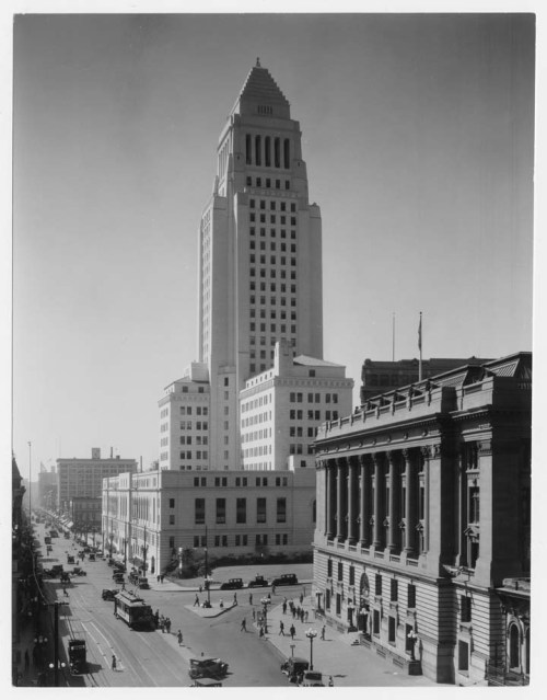 Backlit by the morning sun: Los Angeles City Hall, looking south on Main Street, 1928.