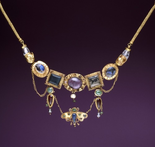 Elaborate diadems or necklaces featuring centerpieces of inlaid stones, pendants, and beaded chains 