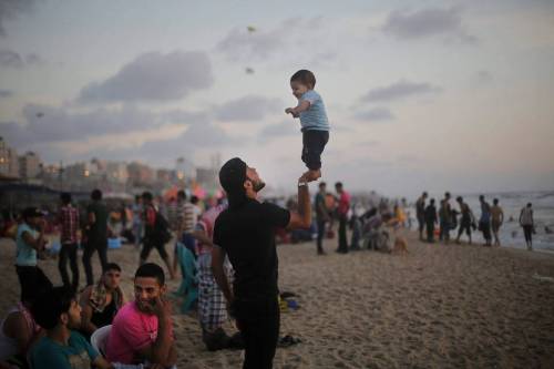 heart-full-of-islam:thebowspring:A Palestinian father playfully balances his son on his right hand a