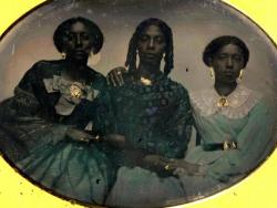 chubachus:  Hand-colored tintype portrait of three unidentified African American women, c. 1856. Source: Harvard Library. 