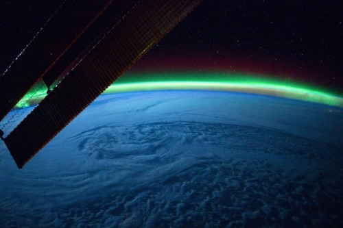 nubbsgalore: the earth adorned in a phosphorescent crown of light, as supercharged plasma spewed fro