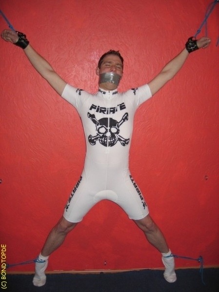 cgtwoface2:  gearjockmo:  Bicyclist forced to endure some torment.  He should be wearing a blindfold and earplugs at least. A Birdlocked Pico or Kali’s Teeth should keep that unsightly erection under control. Maybe a good chest and abs flogging would