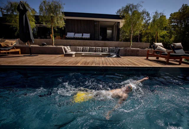 Rudy Garcia-Tolson swims a backstroke in actor David Duchovny’s backyard pool in Malibu, Calif.Credit...Christian Monterrosa for The New York Times 