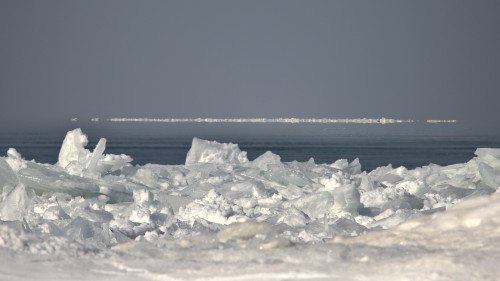 Got a mirage going on at Lake Michigan.  What looks like a cloud is probably a mirage of snow on the