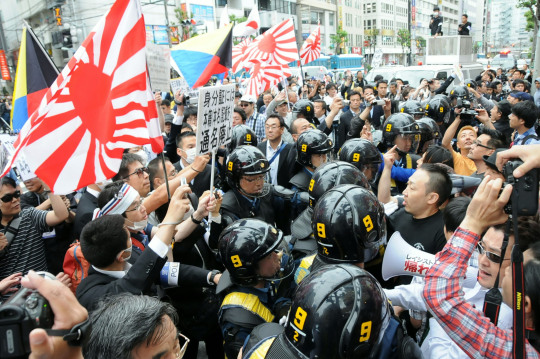 ayellowbirds:  agingerwithaseoul:  I hadn’t seen any English reports on this but its too good not to share. So right now there are pretty crazy right-wing nationalist sexists in Japan. They’re dressing up in WWII military outfits, they’re standing