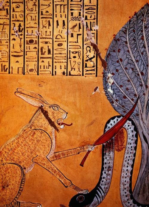 grandegyptianmuseum:Under a sacred sycamore the sun god Ra, in the form of a cat, slays the snake Ap