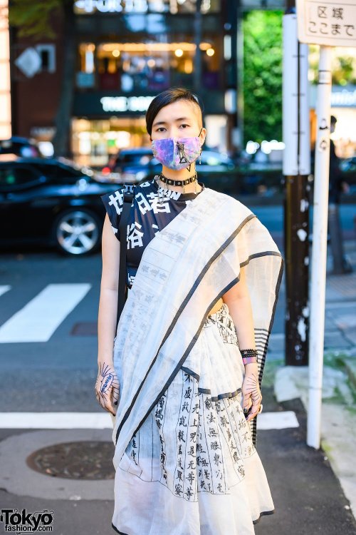 Japanese PHD neuroscience student Yoritam (she/they) on the street in Harajuku wearing a kanji print