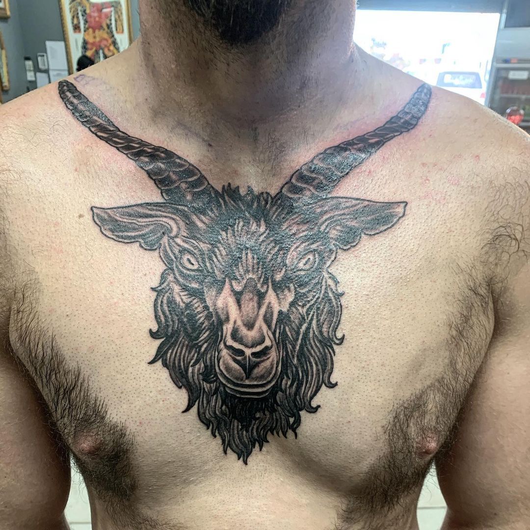 Black Ink Goat Skull Tattoo On Man Chest