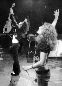 pagingpage:  pinkfled:  Robert Plant and Jimmy Page performing during a Led Zeppelin show - 1973  poetic beauty at its finest 