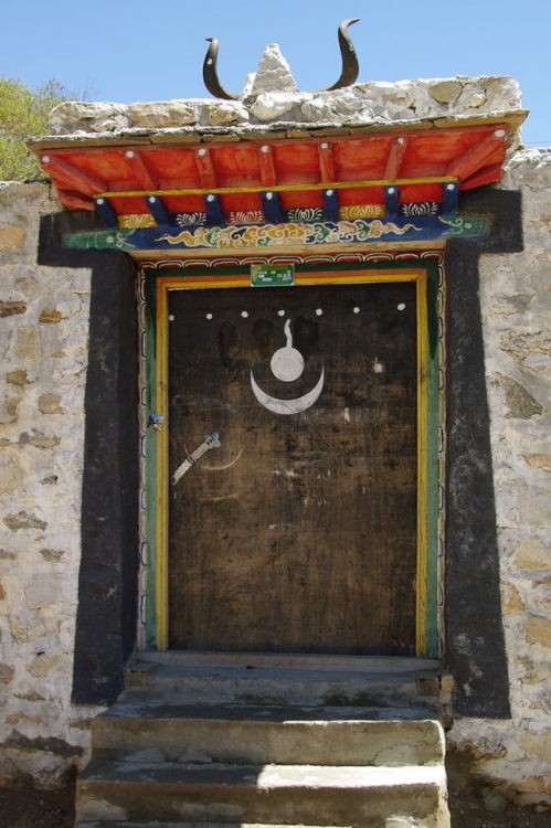 artofprayer:Door in Tibet with Bon religious symbolism.