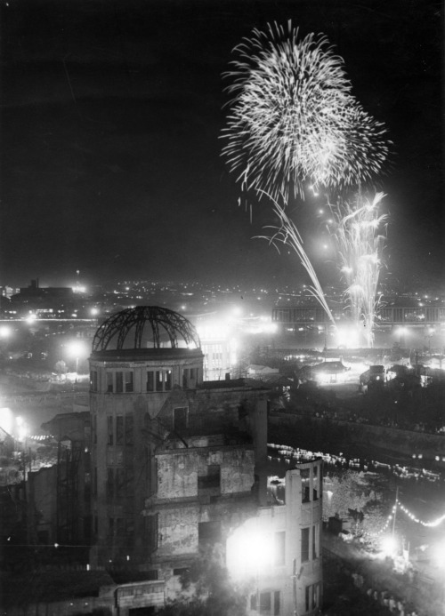 Fireworks explode on the 10th anniversary of the Hiroshima A-Bomb dropping at the Hiroshima Peace Me