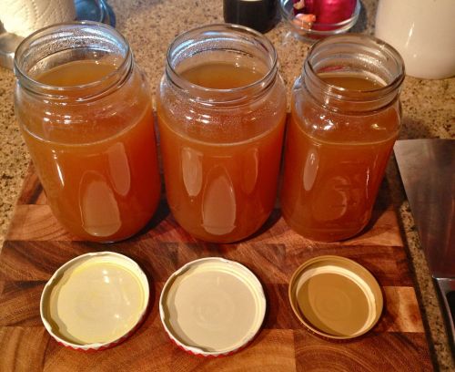 Jars of homemade chicken stock, one of my regular kitchen staples, made by simmering lots of chicken