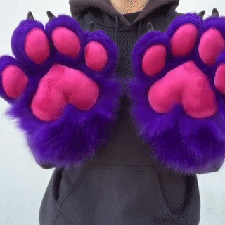 purple paws with pink pawpads. the person wearing wiggles their fingers and waves