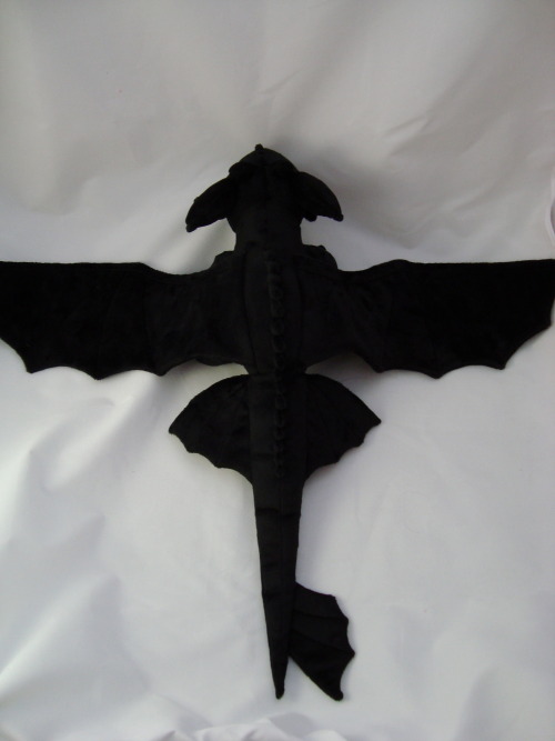 spaceplush:  Toothless is made entirely from minky fabric. He has embroidered details and suedecloth claws. He’s approximately 24 inches long with a 32 inch wingspan. He was really hard to photograph since he’s so big! He’s very soft and his feet