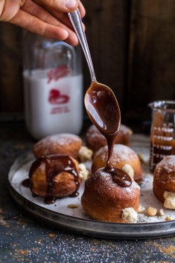 sweetoothgirl:  Peanut Butter Cheesecake Doughnuts with Salted Chocolate Bourbon Caramel  oooooh