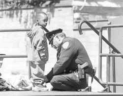 ososober:      While taking a routine vandalism report at an elementary school, an officer was interrupted by a little boy about six years old. Looking up and down at his uniform, he asked, “Are you a cop?” “Yes,” he replied and continued writing