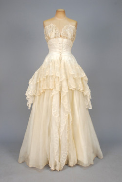 historicaldress:   CHRISTIAN DIOR APPLIQUED ORGANDY BALLGOWN, c. 1955 Cream organdy over glazed cotton, decorated with loops of organdy embroidered in a candy stripe and organdy dots, fitted bodice having sheer scalloped top above self buttons, very full