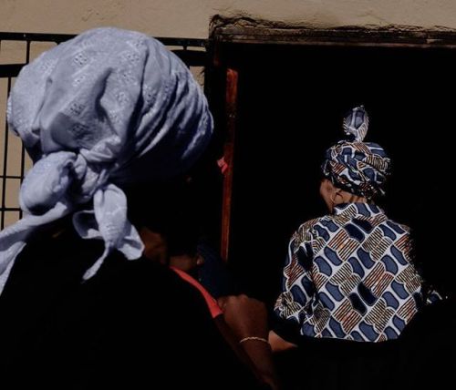 dolm:Young wife enters her husband’s mother’s home before the start of their Xhosa wedding ceremony.