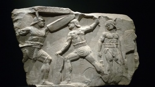 From a Roman funerary monument, 30 BC.Shows two provocator gladiators fighting. The writing on the e