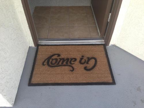 downrabbitholes:Clever doormat stencil reads Come In/Go Away depending on which side it is read.  