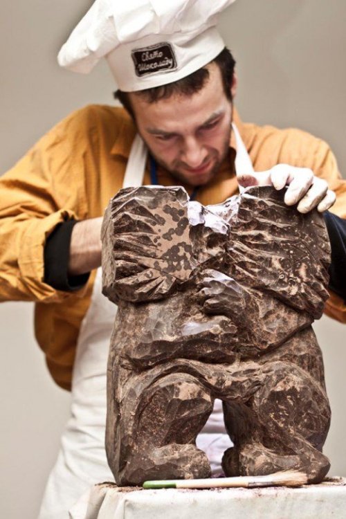  A chef carving a sculpture of two kissing lions from chocolate during the Chocolate Festival in Lvi