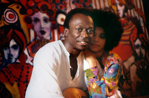 twixnmix:Miles Davis and his wife, funk singer, Betty Davis in front of one of his paintings at thei