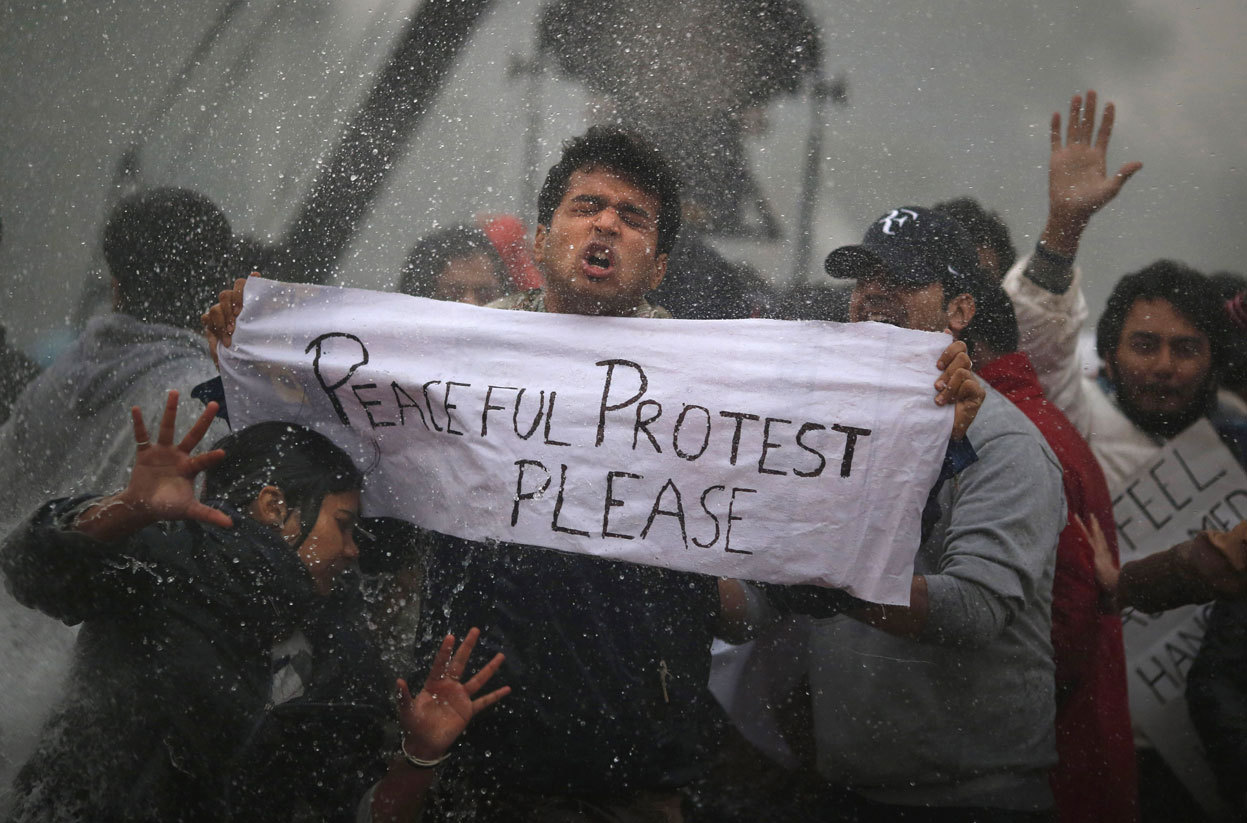 From Violent Protests in India Over Rape Case, one of 26 photos. Protesters react as Indian police officers use a water cannon to disperse them near the India Gate as they protest against the gang rape and brutal beating of a 23-year-old student on a...