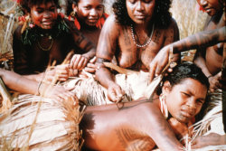 Yearningforunity:    1958 Image Of A Motuan Female Tattooing The Back Of A Young