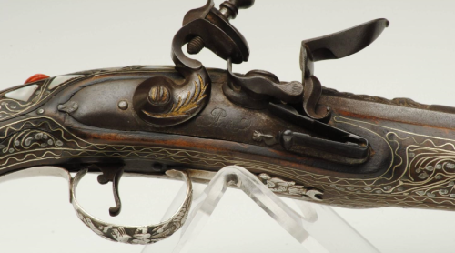 Turkish flintlock pistol decorated with silver, mother of pearl, and polished red coral. Early 19th 