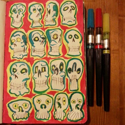 Adding color to previously doodled skulls. adult photos